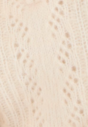 Lichtbeige gebreide sweater met een delicate kantpatroon, verhoogde texturen en kleine stipachtige accenten door de stof heen.