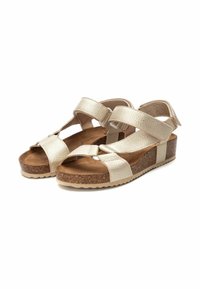 Sandalias de cuña con un upper texturizado en beige claro, correas ajustables y una plantilla de corcho con una suela de goma para mayor agarre.