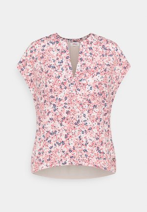 Ärmellose V-Ausschnitt-Bluse mit rot, pink und blauem Blumenmuster auf hellem Hintergrund, mit einem geschwungenen Saum.