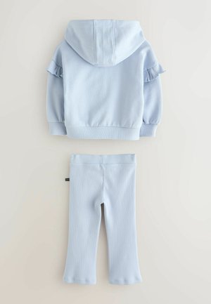 Light blue hoodie with ruffle accents on sleeves and matching pants, both in soft fabric with a fitted design and ribbed texture.