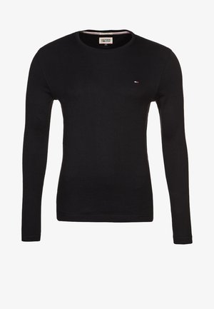 Schwarzer Pullover mit langen Ärmeln und Rundhalsausschnitt, mit kleinem Tommy Hilfiger Flaggenlogo auf der Brust und einem markenprägenden Nackenetikett.