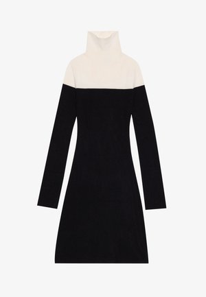 Vestido de gola alta com uma parte superior em tom de creme e uma parte inferior preta sólida. Feito de um tecido suave, com mangas longas e uma silhueta ajustada.