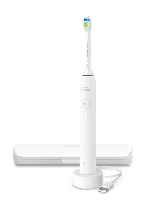Witte Philips Sonicare elektrische tandenborstel staand op een ronde oplaadbasis met USB-kabel en een gesloten reisetui erachter.