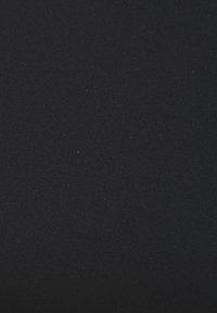 Black ribbed fabric with a smooth texture, featuring a consistent pattern and fine detailing, suitable for clothing or upholstery.