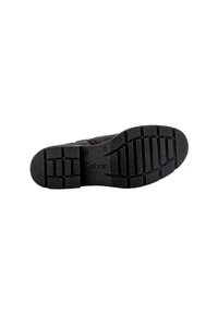 Suela negra de zapato con dibujo texturizado, que presenta un patrón de agarre resistente y el nombre de la marca "Gabor" grabado en el material.