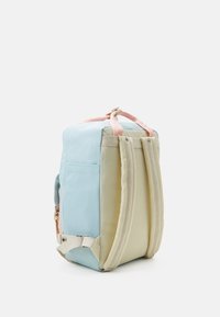 Backpack with pastel blue, pink, and beige fabric, featuring two padded shoulder straps, a side pocket, and reinforced stitching details.
