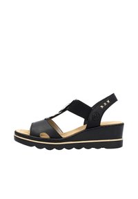 Sandali wedge neri con tomaia in pelle liscia, cinturini elastici e suola in gomma testurizzata con bordi scallop. Dettaglio del logo evidente incluso.