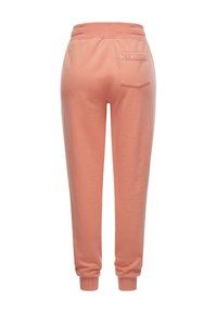 Rosa sweatpants med avslappnad passform, elastisk midja och muddade anklar. Har en bakficka och en liten textdetalj. Mjuk material.