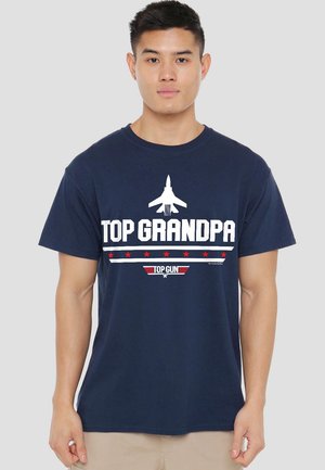 Navy blue cotton t-shirt featuring "TOP GRANDPA" in bold white text, a graphic of a jet, and red star accents. Short sleeves and crew neck design.