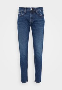 Ciemnoniebieskie dżinsy o wąskim kroju, z wyblakłym wykończeniem, pięcioma kieszeniami i subtelnym przetarciem. Zapięcie na metalowy guzik i zamek błyskawiczny.