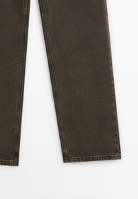 Mörkbruna denimbyxor med rak passform, med en texturerad yta, överstygn längs sömmarna och en ren nederkant utan dekorationer.