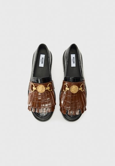 Black patent leather shoes with a brown, fringed front and gold detailing. The brand label "Moschino" is visible inside the shoe.