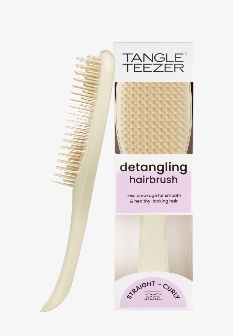 Beige Tangle Teezer -hiusten harja, jossa joustavat harjakset. Suunniteltu vähentämään hiusten katkeilua ja tekemään suorasta tai kiharasta hiuksista sileät ja terveennäköiset.