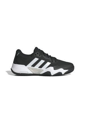 Chaussure de sport noire avec un upper texturé, des rayures blanches et une semelle blanche contrastante. Présente un design à coupe basse et une semelle extérieure en caoutchouc.
