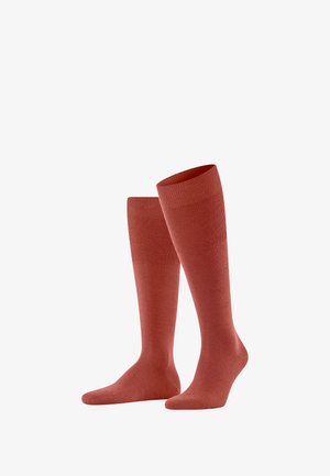 Calze fino al ginocchio in una calda tonalità rossastra, con una texture liscia e una parte superiore a coste. Realizzate in tessuto morbido per comfort e vestibilità.