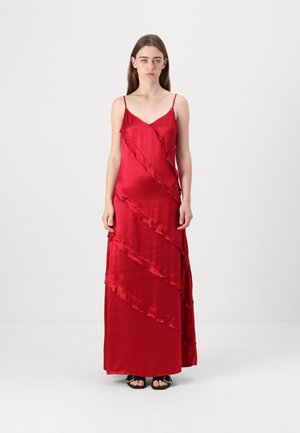 Red satin maxi dress with thin straps, featuring diagonal ruffled accents, a v-neckline, and a smooth, glossy texture.
