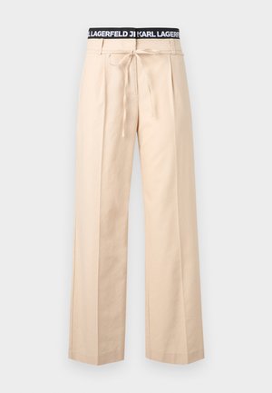 Pantalon beige à jambes larges avec plis, cordon de serrage à la taille et ceinture élastique noire ornée du texte blanc "KARL LAGERFELD".