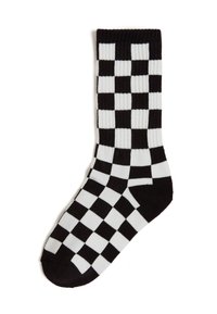 Calzino a scacchi bianco e nero, con texture a costine, lunghezza fino al polpaccio e realizzato in morbido materiale a maglia. Design a scacchiera notevole.