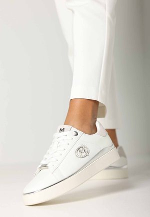 White sneakers with a smooth leather finish, featuring a rounded toe, lace-up front, silver accents, and a subtle logo on the side.
