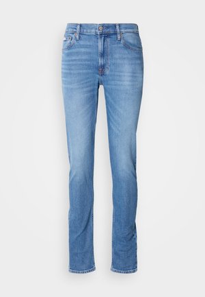 Svetlo modri skinny jeans s sprednjim gumbom in zadrgo, pet žepov ter subtilnim zbledelostjo na stegnih in kolenih.