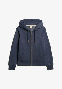 Sudadera con cremallera de color navy hecha de un tejido suave, con capucha con cordón, dos bolsillos frontales y un logo sutil en el pecho. Cremallera de color cobre.