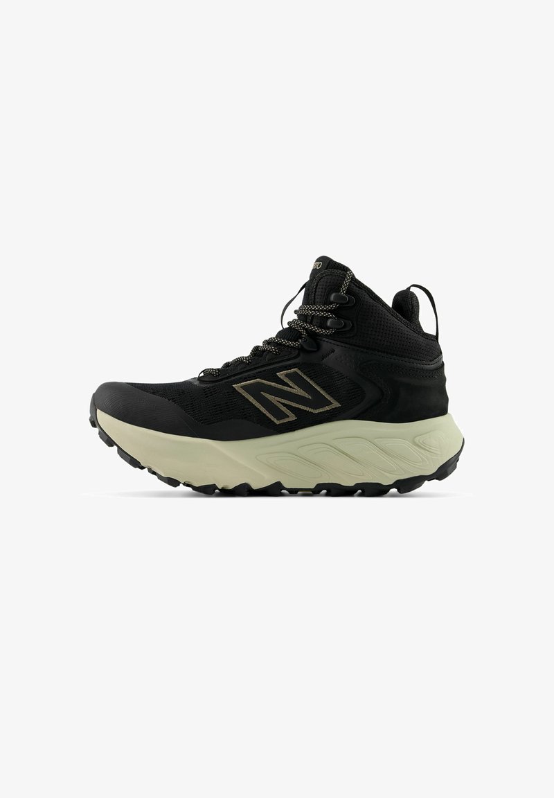 Svart hög sneaker med texturerad överdel, tjock mellansula och gummiyttersula. Har grå accenter och förstärkta hål för snörena.