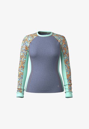 Long-sleeve top in blue with floral patterned arm panels in orange and teal. Features a fitted design and soft texture.