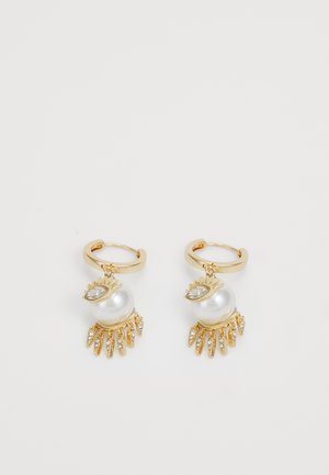 Gold hoop earrings with a large white pearl pendant, featuring leaf-shaped accents and small clear crystals dangling below.