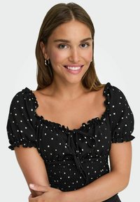 Czarna bluzka z puff sleeves w białe kropki, teksturowana tkanina, kwadratowy dekolt, szczegóły ze sznurkiem z przodu oraz guma w talii.