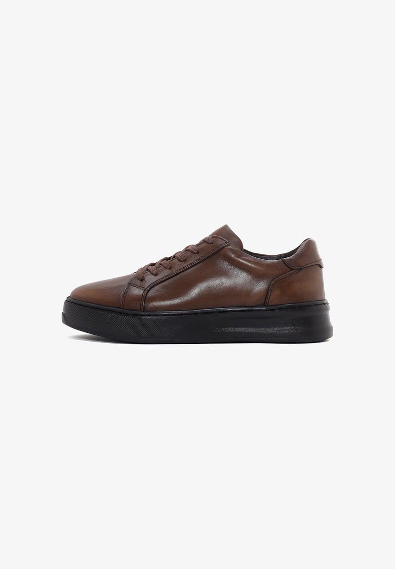 Brown leather sneakers with a smooth finish, rounded toe, contrasting black rubber sole, and six eyelet lace-up closure.