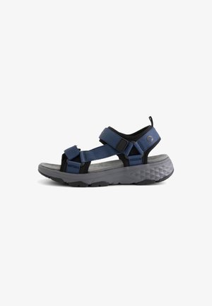 Blue and black adjustable strap sandal with thick textured gray sole designed for outdoor or casual wear.