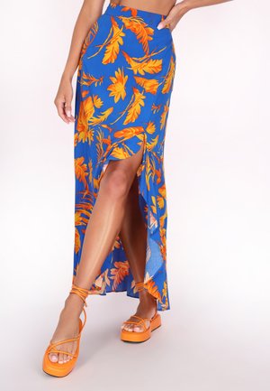 Blue floral maxi skirt featuring orange floral patterns, high slit design, and paired with orange platform sandals with crossed straps.
