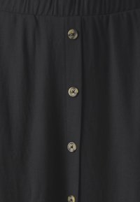 Black button-up skirt with an elastic waistband. Features large tan-colored buttons down the front and a smooth, textured fabric.