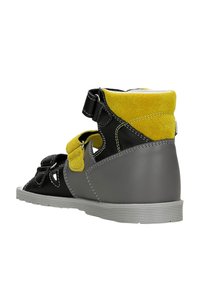 Scarpa alta in pelle nera con dettagli in suede giallo, suola in gomma grigia, cinturini in velcro e dettaglio traforato per la traspirabilità.
