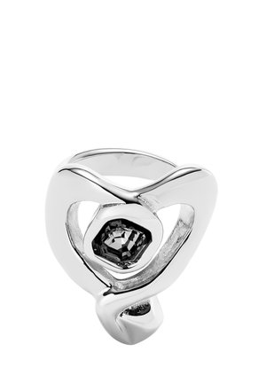 Anillo de plata con un diseño suave y curvado, que presenta una gema negra hexagonal en el centro, incrustada en un marco calado.