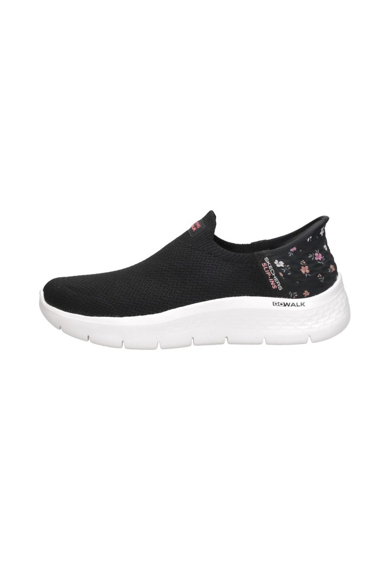 Zapatilla negra sin cordones con un upper texturizado, suela blanca y acentos de patrón floral en el talón. Diseño ligero y flexible.