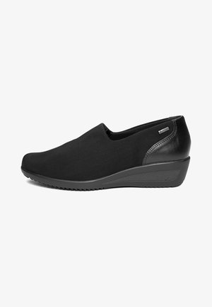 Black slip-on wedge shoe with smooth upper, textured sole, and Gore-Tex label on the heel for waterproofing.