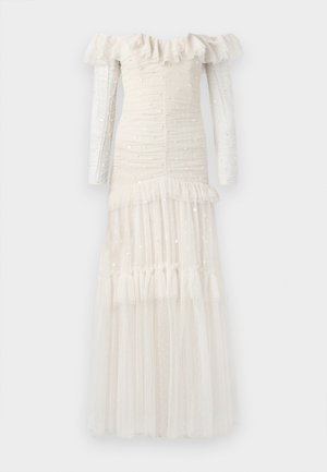 Vestido de manga larga y hombros al aire en color crema pálido. Tejido texturizado con volantes, fruncidos y falda de tul en capas adornada con lentejuelas.