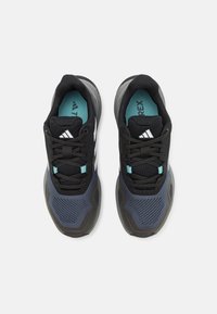 Black and navy athletic shoes with mesh upper, textured detailing, streamlined shape, and teal accents on the tongue and laces.