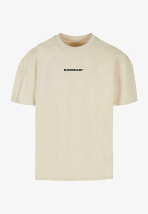 T-shirt en coton beige à manches courtes, col rond, et logo imprimé noir "MJGONZALES™" sur le devant. Texture lisse.