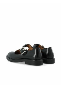 Black leather shoes with a rounded toe, single strap adorned with silver hardware, and a flat rubber sole. Features a smooth texture.