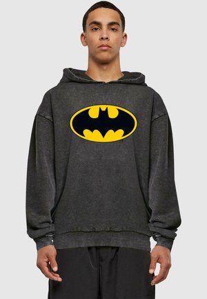 Gray oversized hoodie with a large yellow Batman logo on the front. Features ribbed cuffs and waistband, made of soft cotton blend material.