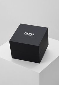 Black square box with a matte finish, featuring the "BOSS" logo in white. Simple design with a lid, suitable for gift packaging.