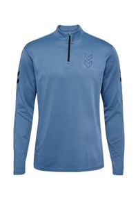 Blauw langemouwen kwart-rits top gemaakt van textuurstof. Bevat een zwarte rits en strepen op de mouwen, met een chevronpatroon op de borst.