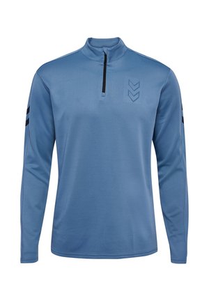 Blauw langemouwen kwart-rits top gemaakt van textuurstof. Bevat een zwarte rits en strepen op de mouwen, met een chevronpatroon op de borst.