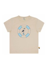 T-shirt corto beige chiaro con maniche corte, caratterizzato da un logo circolare blu e bianco con un pellicano che indossa un cappello e stivali, realizzato in morbido cotone.