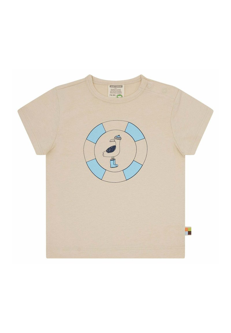 T-shirt corto beige chiaro con maniche corte, caratterizzato da un logo circolare blu e bianco con un pellicano che indossa un cappello e stivali, realizzato in morbido cotone.