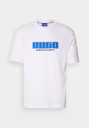 White cotton t-shirt featuring a bold blue "HUGO" logo and black "CREATIVE DEPT." text on the front. Classic crew neckline and short sleeves.