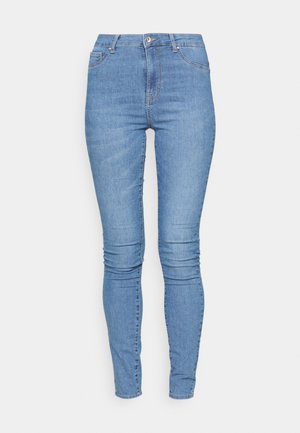 High-waisted skinny jeans in faded light blue denim, featuring five pockets, a zip fly, and a button closure. Smooth texture, seamless design.