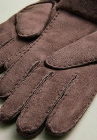 Brown suede gloves featuring a smooth texture, stitched detailing, and a classic five-finger design. Accents include padded knuckles.